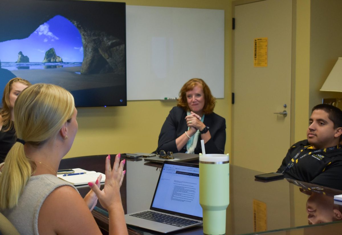 Northerner Arts and Life Editor Jillian Kohls (left) talks with President Cady Short-Thompson (middle).