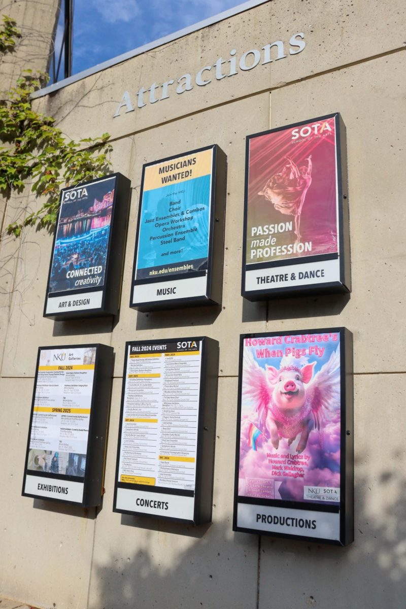 Posters on the side of the SOTA building, featuring a "When Pigs Fly" poster. 