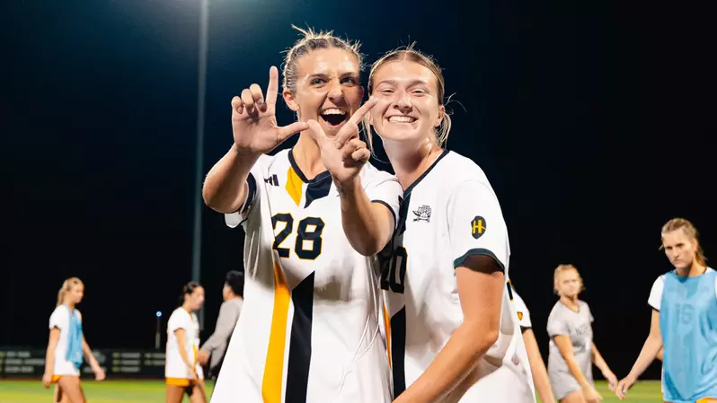 Kaya Vogt (left) and Kylie Anderson (right) celebrate after women's soccer 4-0 victory over Cleveland State.