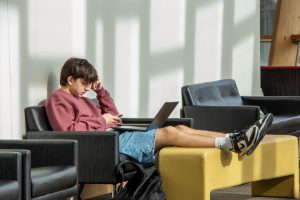 Student relaxing in NKU’s Griffin Hall.