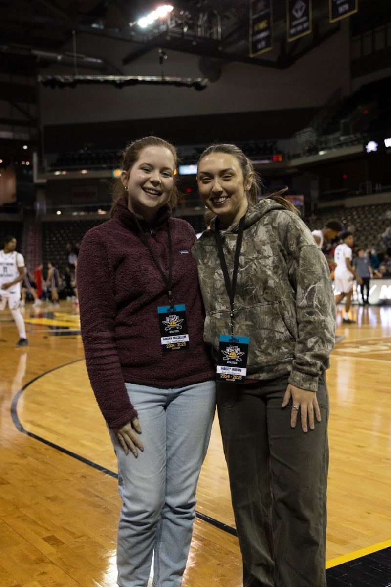 Adelyn McCollum and Hailey Roden shooting a basketball game.