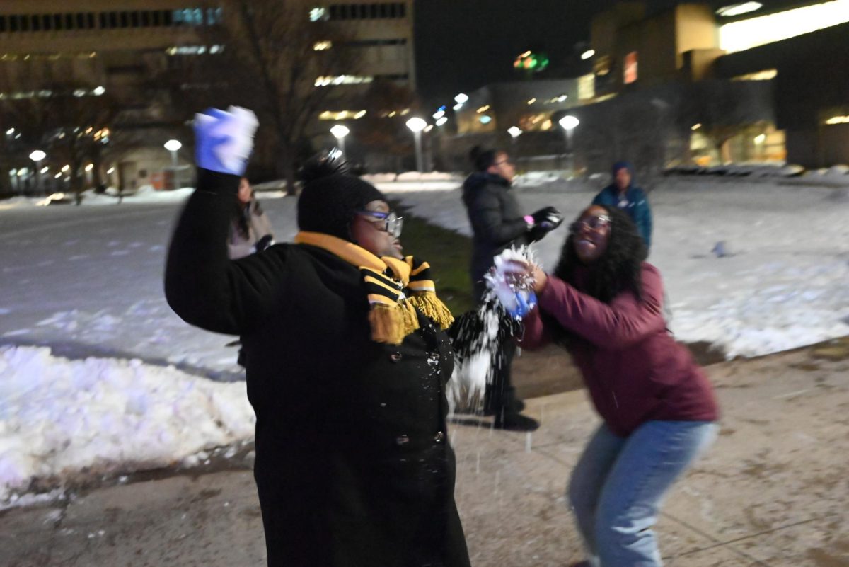 Students at Winterfest engaging in combat by ball of snow.