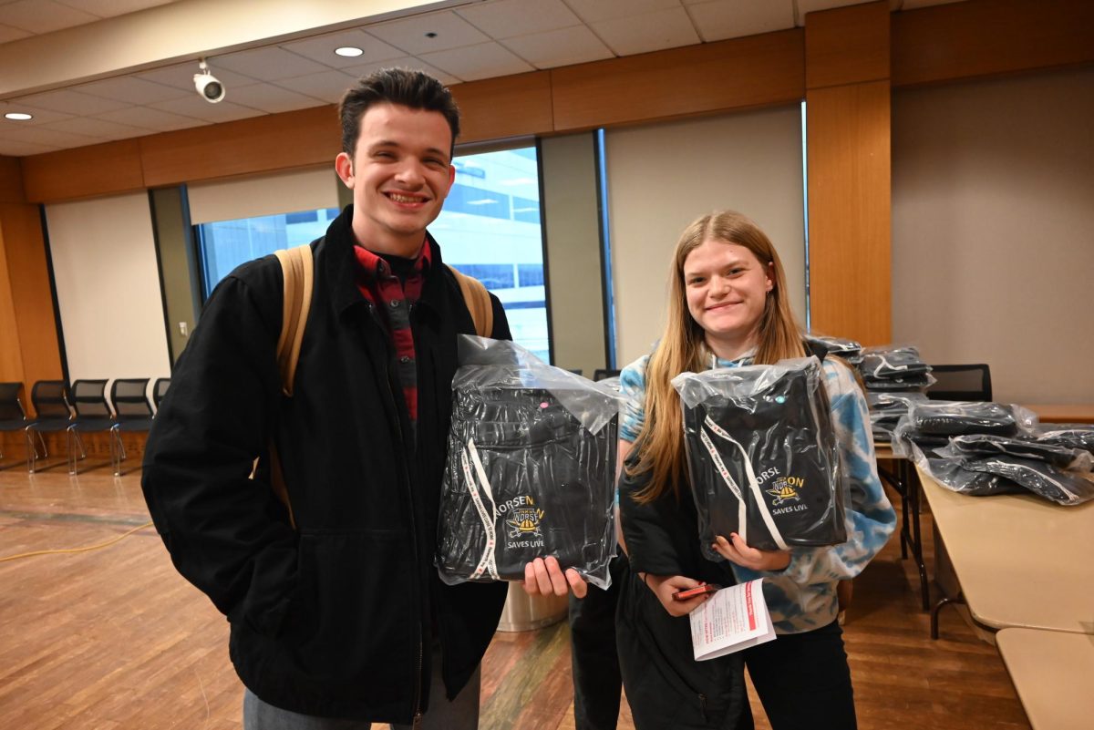 Students showing off their complimentary swag they received for donating blood. 