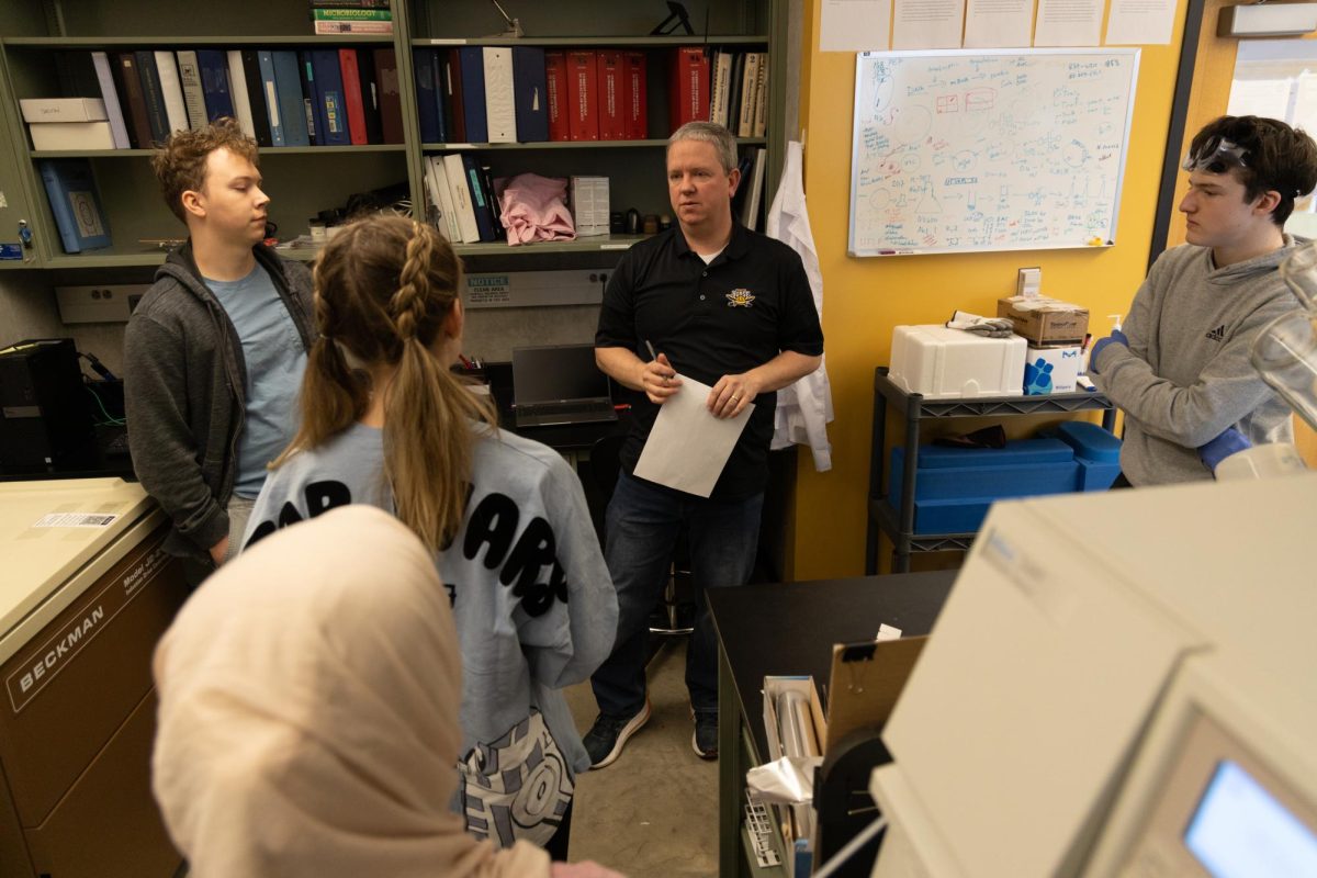 Dr. Michael Guy speaks with students.