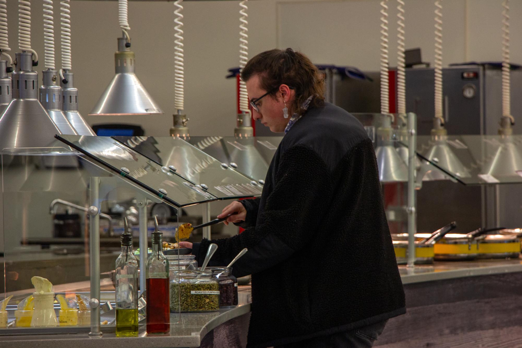 A student fills up their plate at Norse Commons, the only residential dining hall on NKU's campus.