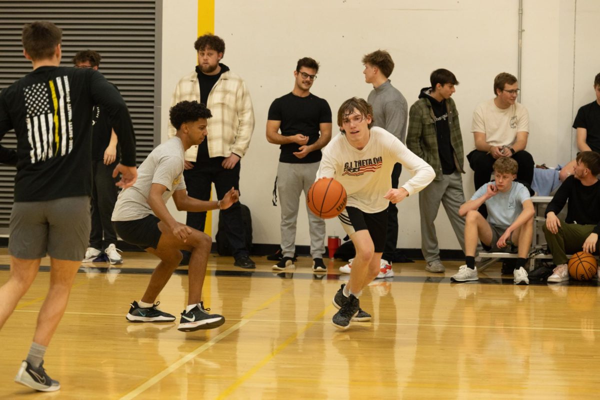 Students attending Theta Chi’s event play basketball. Active chair members observe and connect with interested recruits.