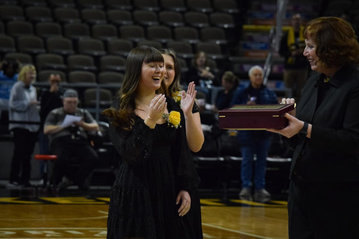 NKU President Dr. Cady Short-Thompson cheering for candidates as they walk onto the court. 