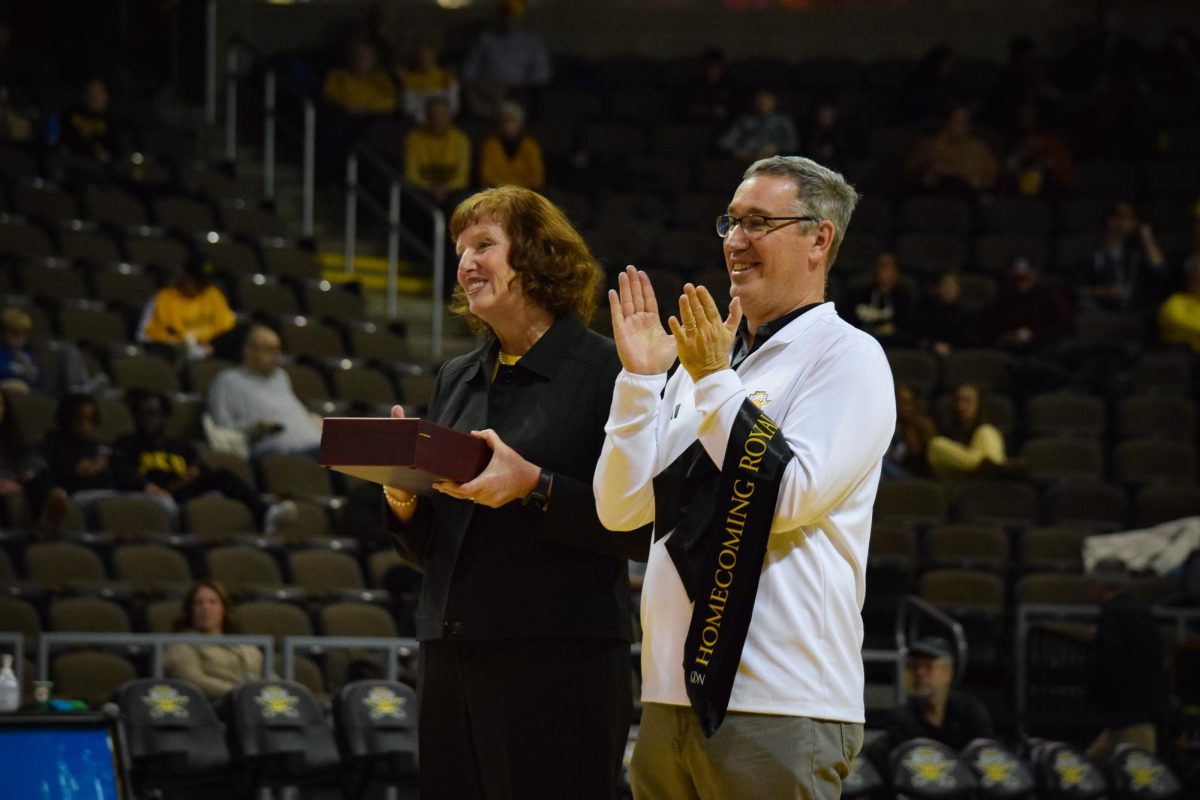 NKU President Dr. Cady Short-Thompson cheering for candidates as they walk onto the court. 