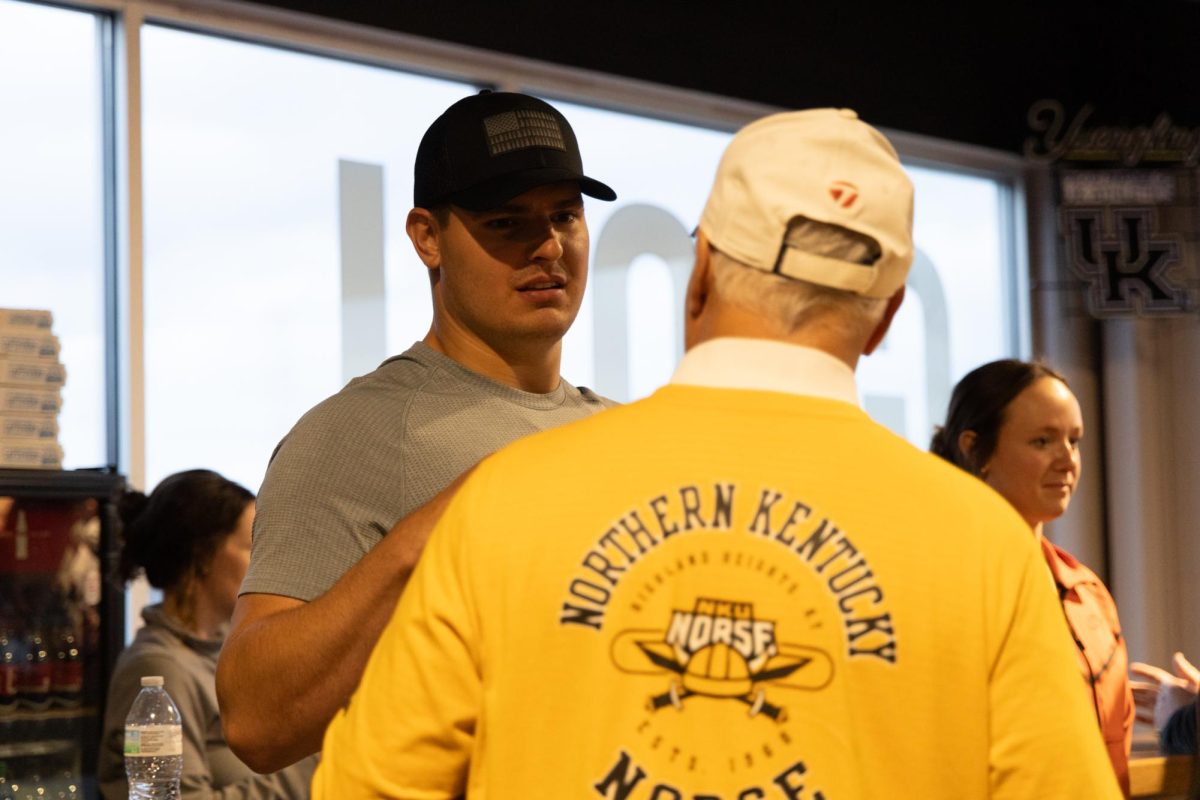 Cincinnati Bengals defensive end Trey Hendrickson talks with an event attendee.