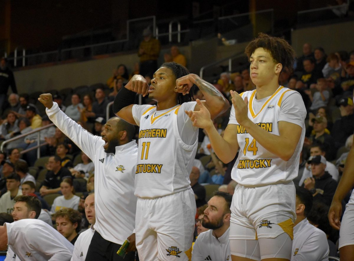 Randall Pettus II (center) and Jeramiah Israel (right) celebrate from the bench as NKU played Detroit Mercy on Feb. 10, 2024. 